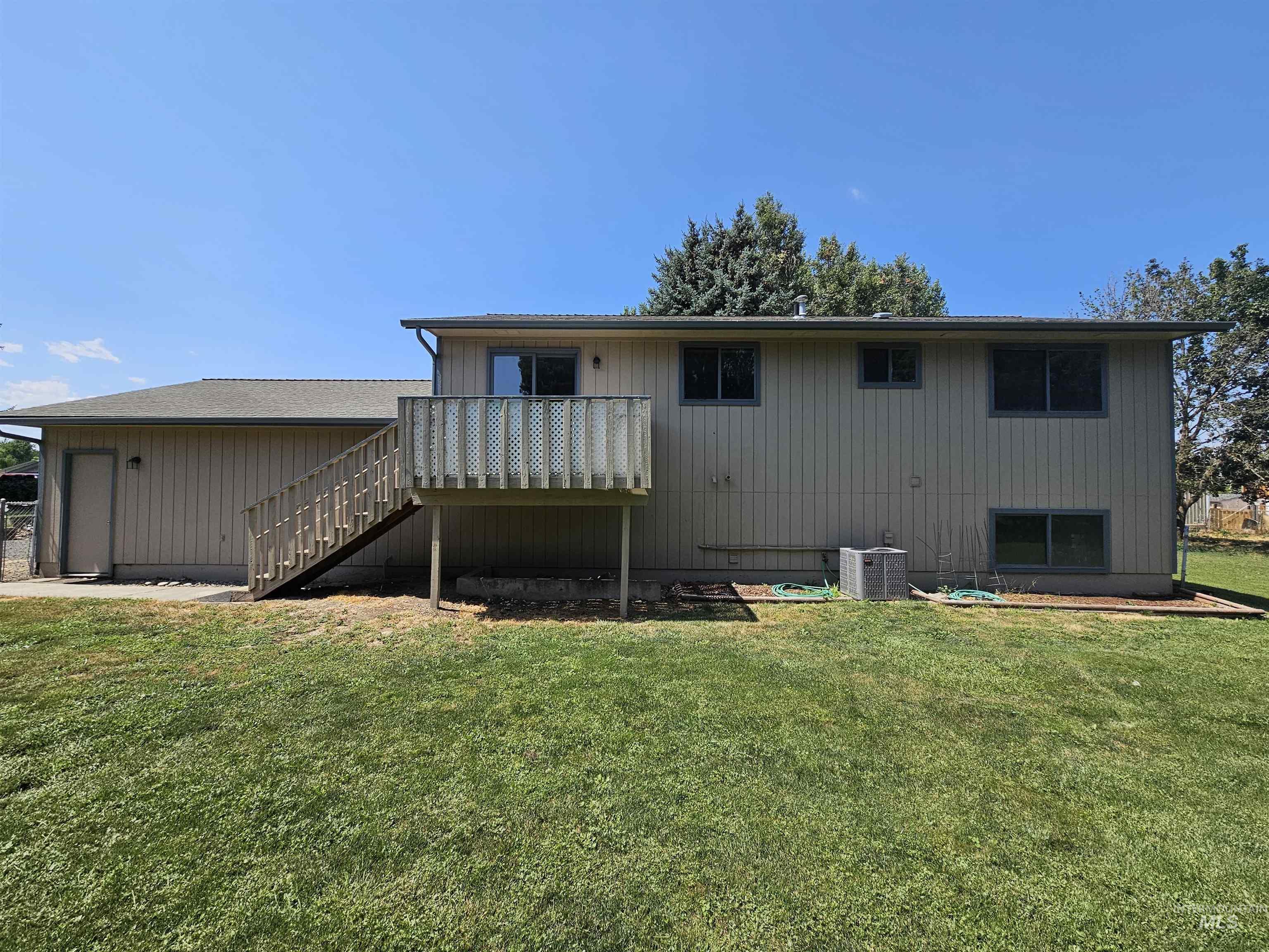 1825 Cedar Avenue Lewiston, ID 83501 - Photo 39 of 39 Rear view of property with stairs, a lawn, and a wooden deck