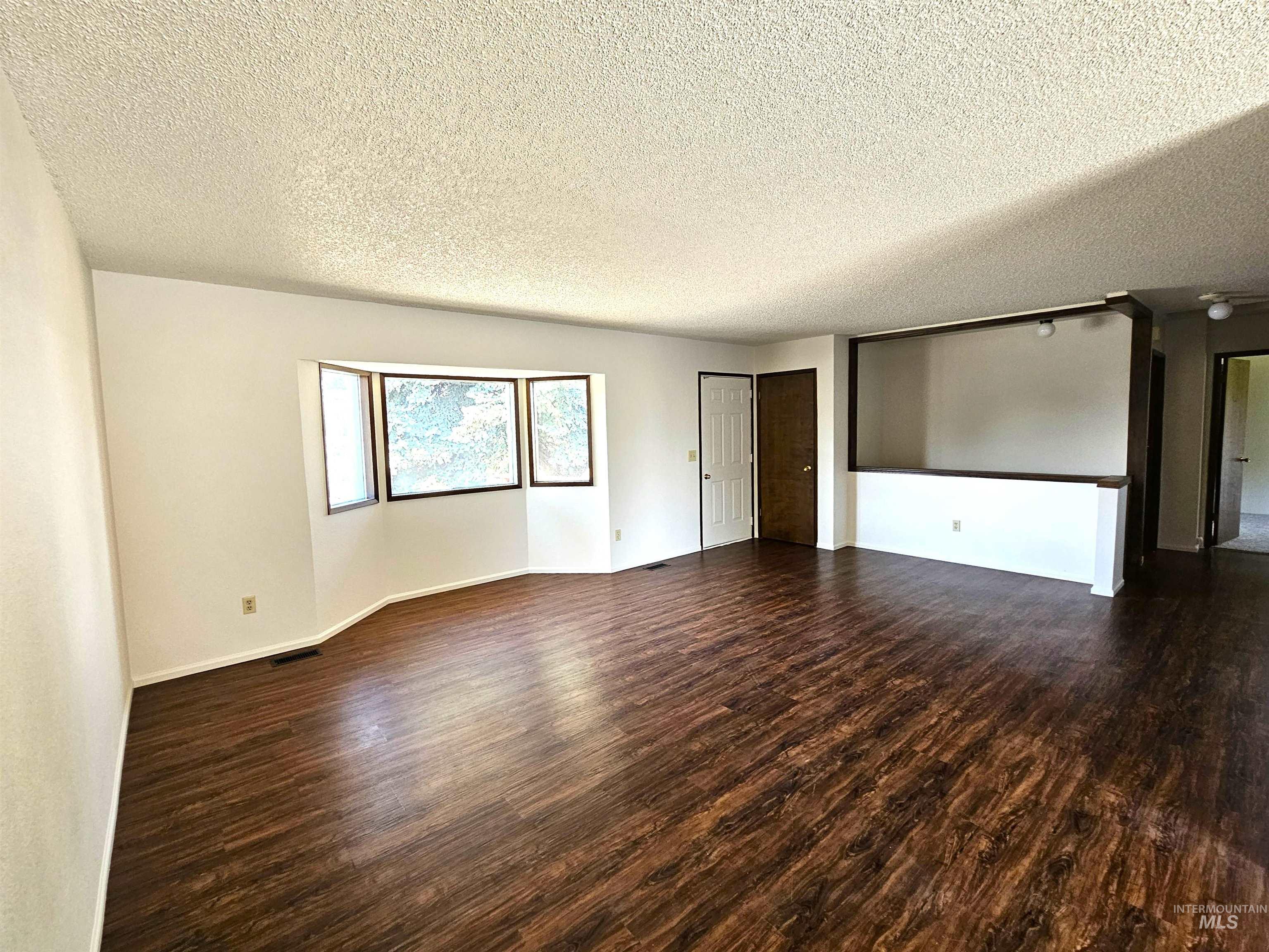 1825 Cedar Avenue Lewiston, ID 83501 - Photo 4 of 39 Spare room with a textured ceiling and dark wood finished floors