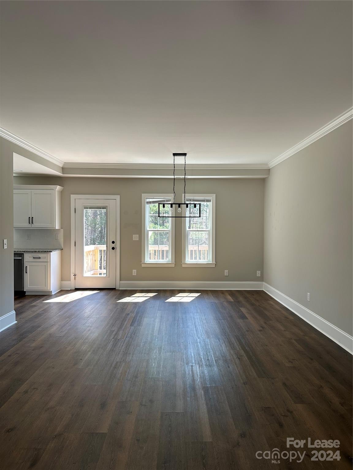 5507 Bucks Garage Road, Unit A Maiden, NC 28650 - Photo 3 of 17 an empty room with wooden floor and windows