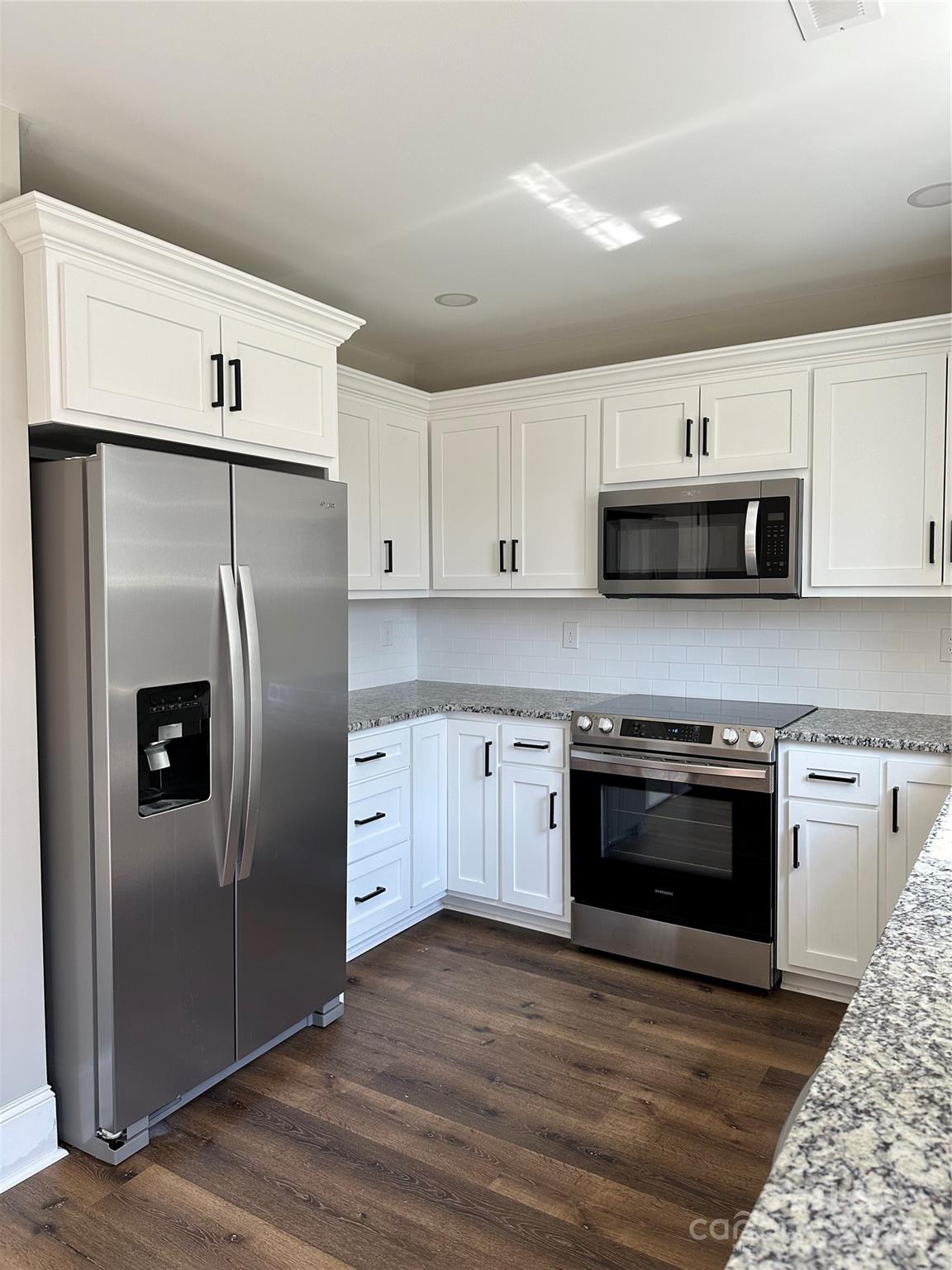 5507 Bucks Garage Road, Unit A Maiden, NC 28650 - Photo 6 of 17 a kitchen with stainless steel appliances granite countertop a refrigerator and a stove top oven
