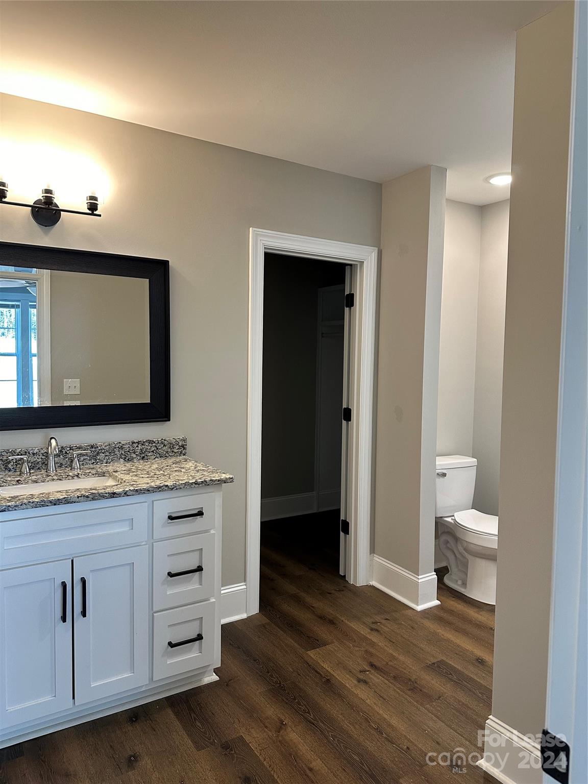 5507 Bucks Garage Road, Unit A Maiden, NC 28650 - Photo 9 of 17 a bathroom with a toilet sink and mirror