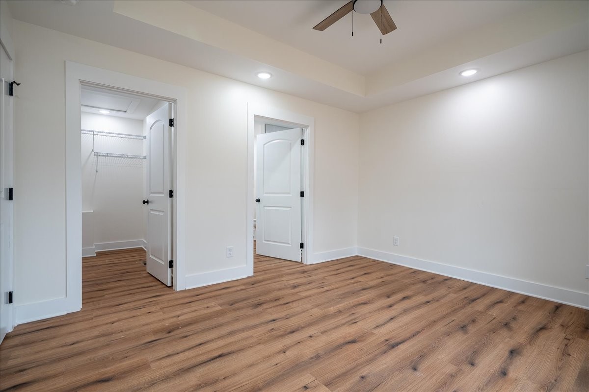 3987 Buffalo Road Summertown, TN 38483 - Photo 17 of 26 an empty room with wooden floor and ceiling fan