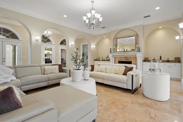 a living room with furniture a flat screen tv and windows