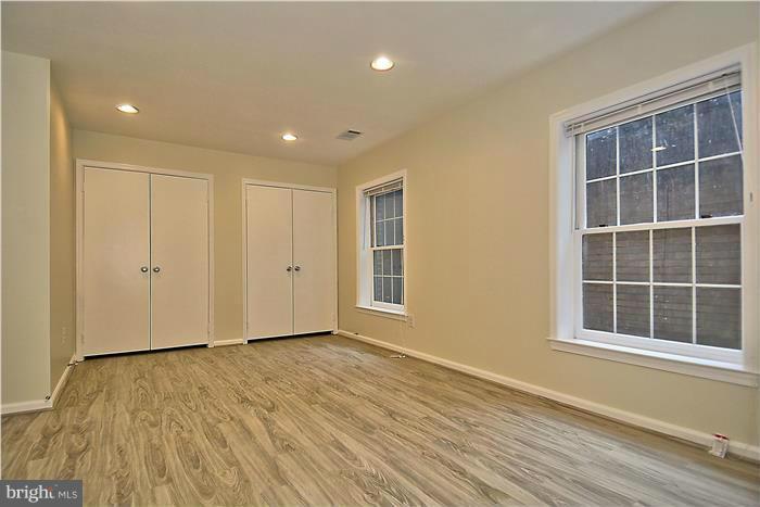 10706 Kings Riding Way, Unit T218 Rockville, MD 20852 - Photo 11 of 17 a view of empty room with wooden floor and windows