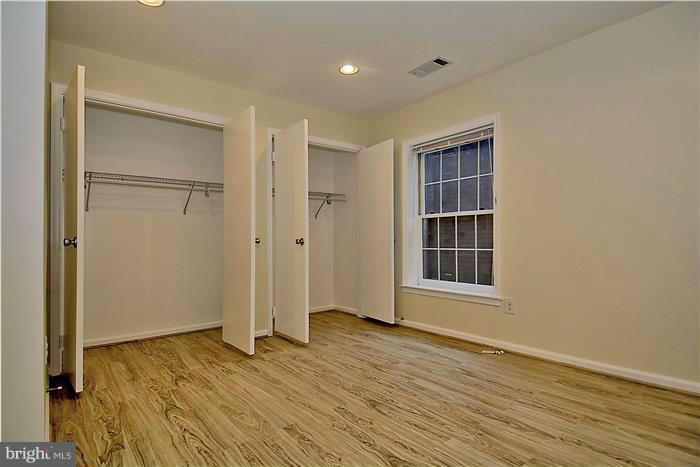 10706 Kings Riding Way, Unit T218 Rockville, MD 20852 - Photo 12 of 17 an empty room with wooden floor and windows