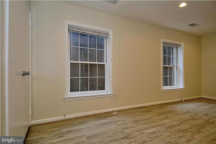 10706 Kings Riding Way, Unit T218 Rockville, MD 20852 - Photo 13 of 17 a view of an empty room with wooden floor and a window