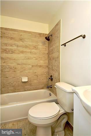 10706 Kings Riding Way, Unit T218 Rockville, MD 20852 - Photo 16 of 17 a white toilet sitting next to a bath tub and a shower