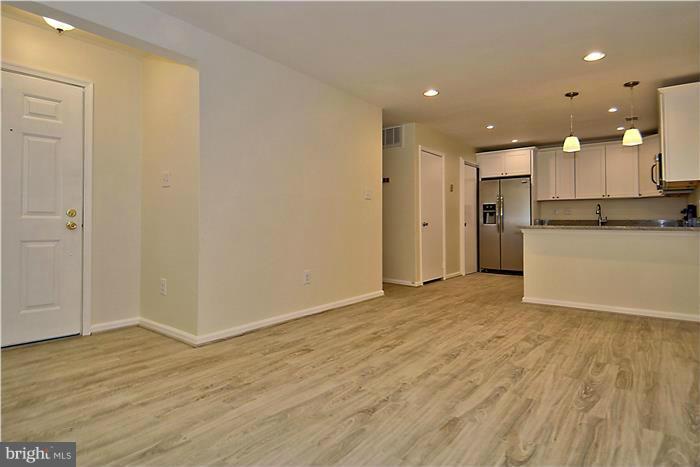 10706 Kings Riding Way, Unit T218 Rockville, MD 20852 - Photo 5 of 17 a view of a kitchen with a refrigerator and a microwave