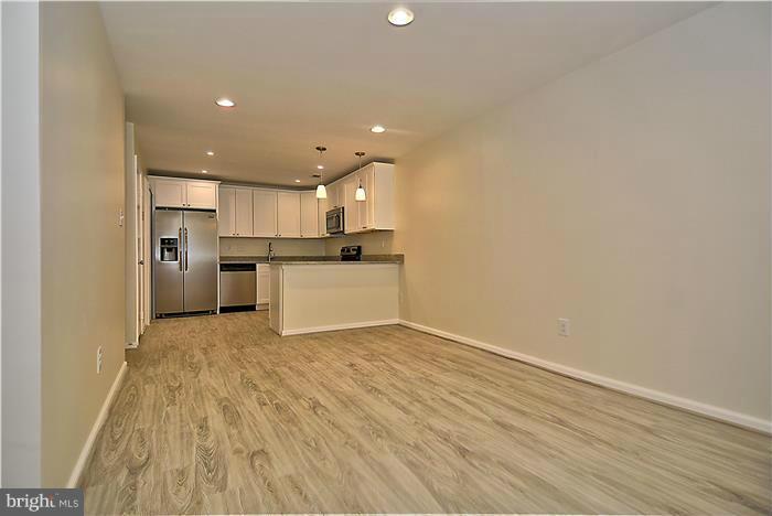 10706 Kings Riding Way, Unit T218 Rockville, MD 20852 - Photo 6 of 17 a view of a kitchen with a sink and a refrigerator