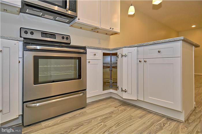 10706 Kings Riding Way, Unit T218 Rockville, MD 20852 - Photo 8 of 17 a stove top oven sitting inside of a kitchen