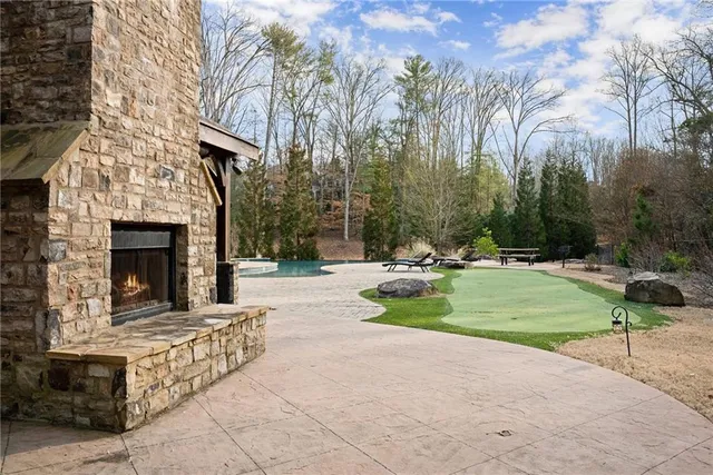 a view of a swimming pool with a yard and trees