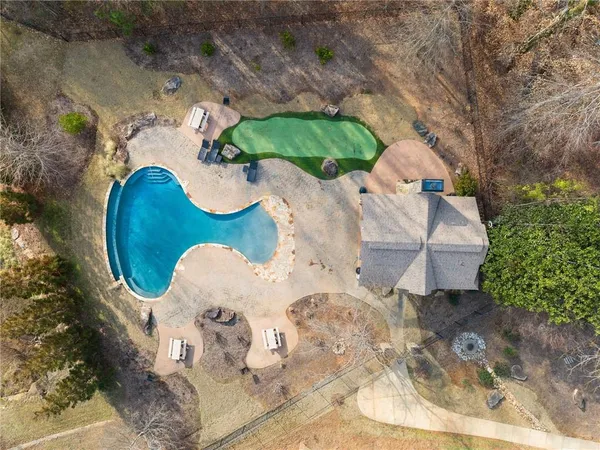 an aerial view of a house with yard swimming pool and outdoor seating