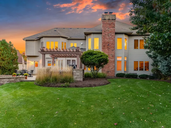 a front view of a house with a garden and plants
