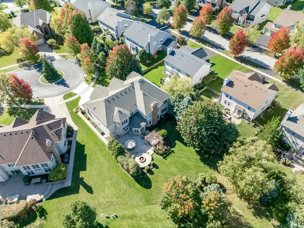 an aerial view of residential house with outdoor space and swimming pool