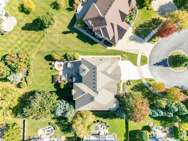 an aerial view of a house with a yard and garden