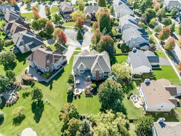 an aerial view of residential house with outdoor space and swimming pool