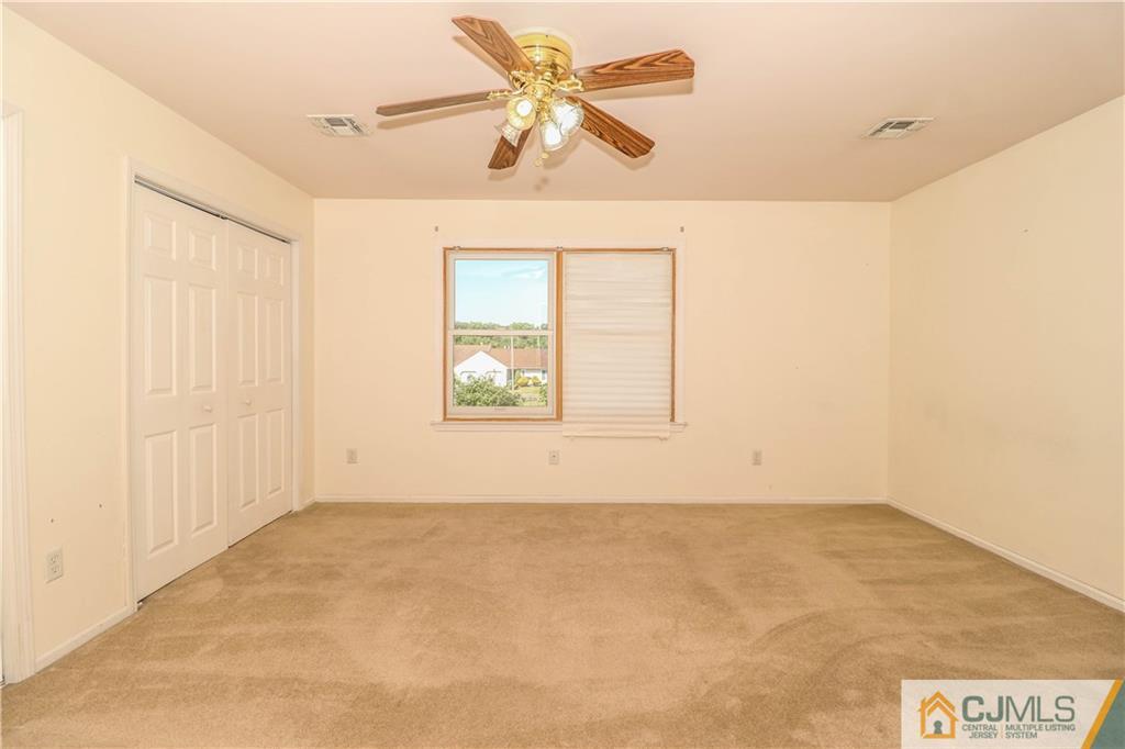 48 Woodbrook Road Edison, NJ 08820 - Photo 11 of 22 an empty room with a window and a ceiling fan