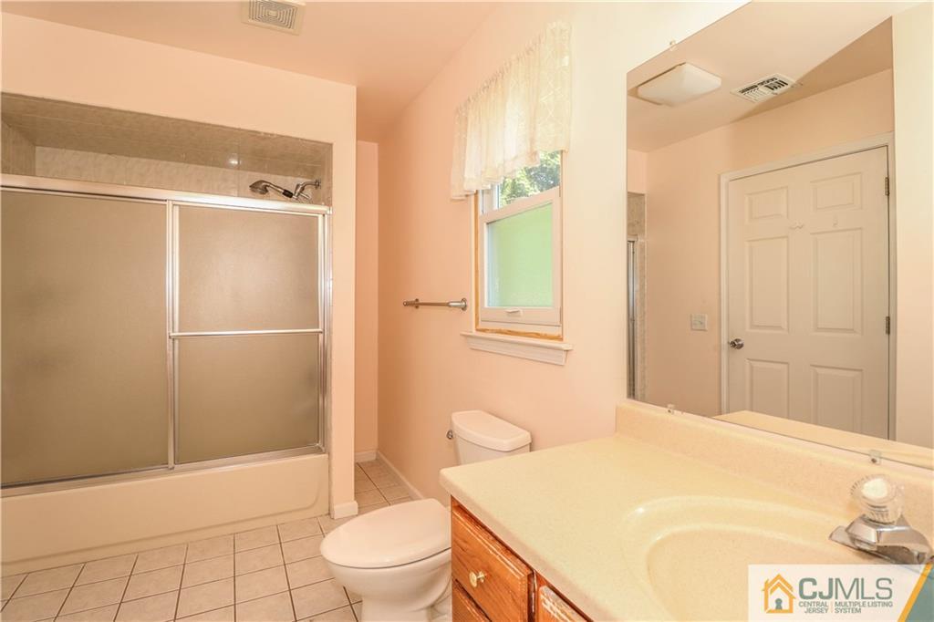 48 Woodbrook Road Edison, NJ 08820 - Photo 14 of 22 a bathroom with a sink a toilet and shower