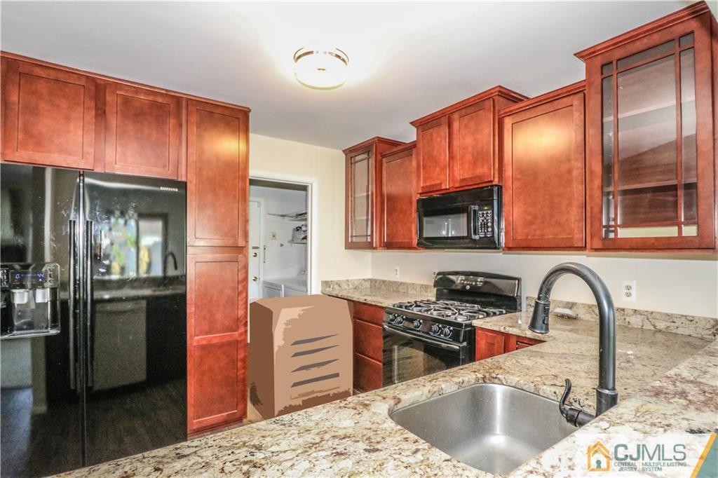 48 Woodbrook Road Edison, NJ 08820 - Photo 4 of 22 a kitchen with stainless steel appliances granite countertop a sink stove and refrigerator