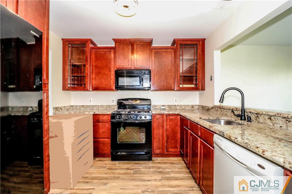 48 Woodbrook Road Edison, NJ 08820 - Photo 5 of 22 a kitchen with stainless steel appliances granite countertop a stove a sink and a microwave