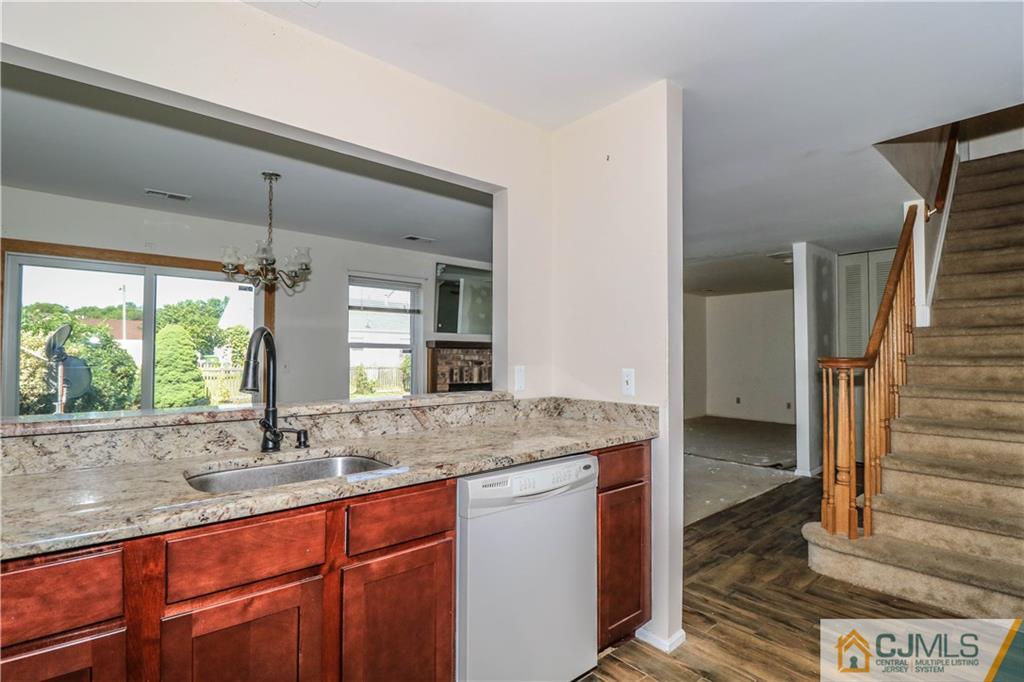48 Woodbrook Road Edison, NJ 08820 - Photo 6 of 22 a bathroom with a granite countertop sink and a large mirror