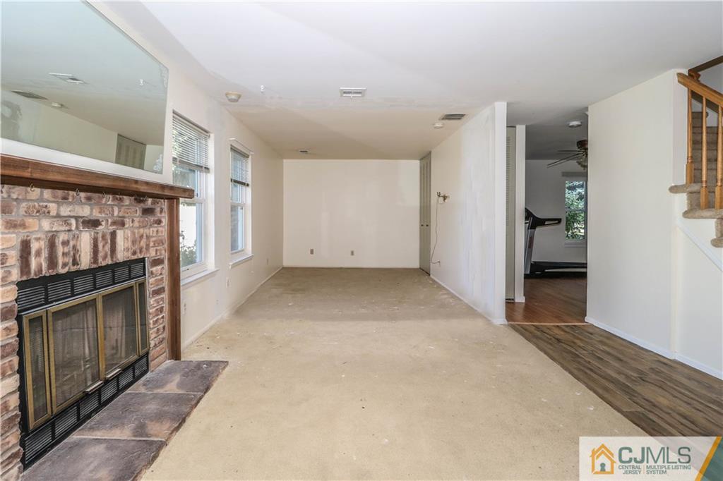 48 Woodbrook Road Edison, NJ 08820 - Photo 9 of 22 a view of empty room with a fireplace and a window