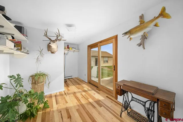 a view of a room with wooden floor and windows