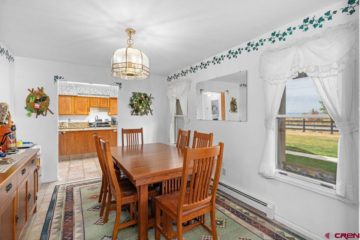 66460 Ogden Road Montrose, CO 81401 - Photo 13 of 40 a view of a dining room with furniture window and wooden floor