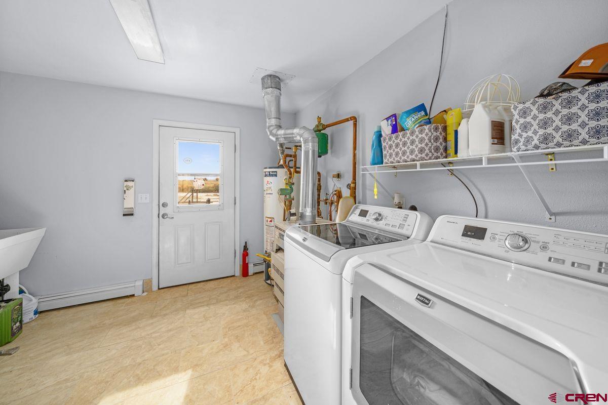 66460 Ogden Road Montrose, CO 81401 - Photo 22 of 40 a view of storage and utility room with washer and dryer