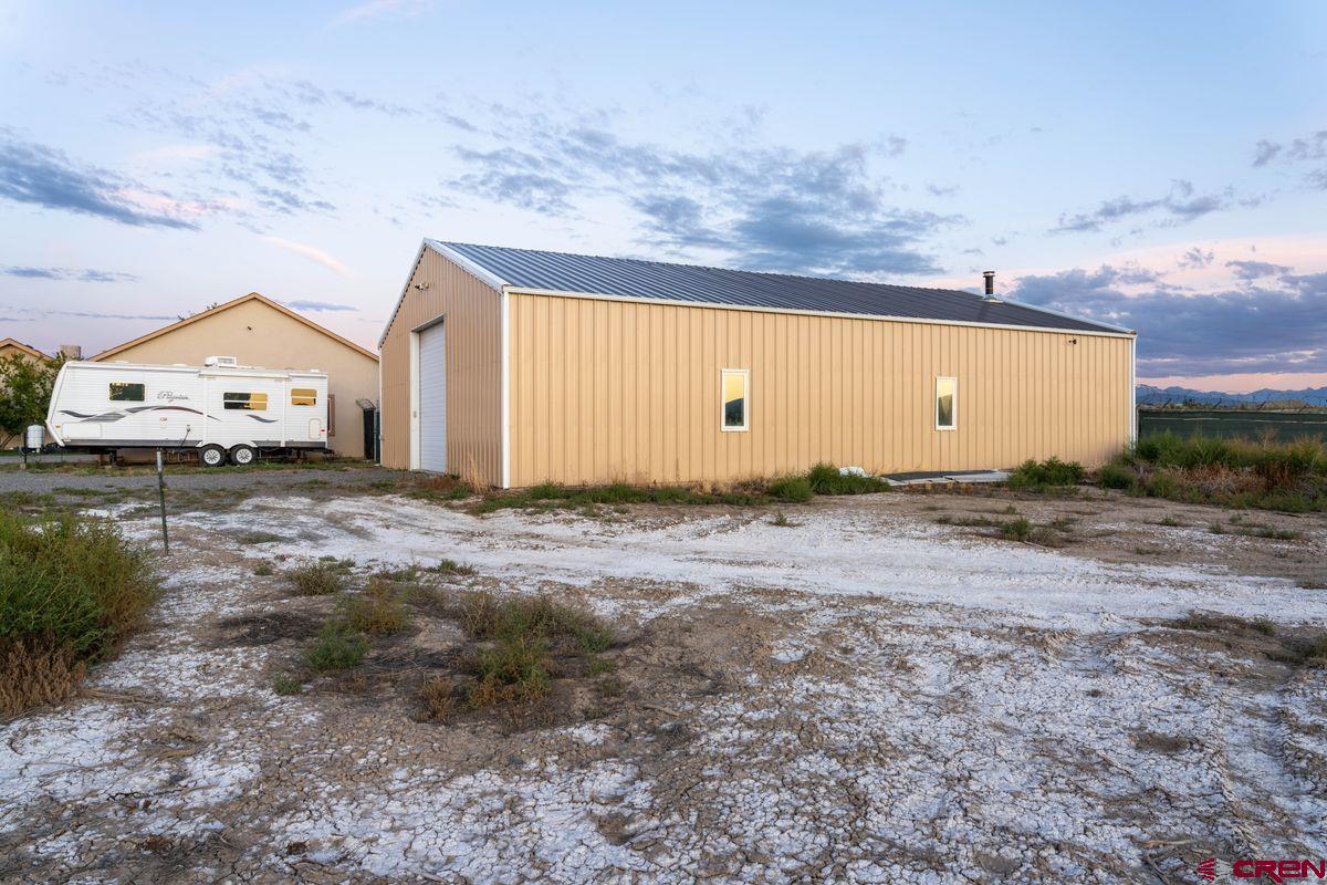 66460 Ogden Road Montrose, CO 81401 - Photo 33 of 40 a view of a house with backyard and trees