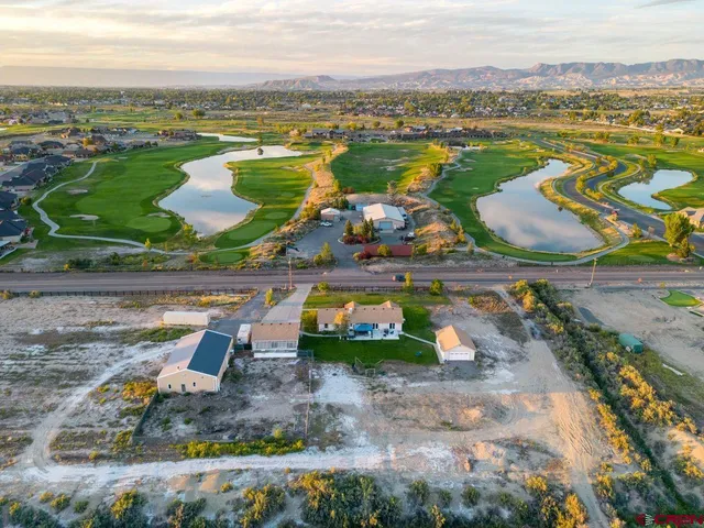 an aerial view of residential houses with outdoor space and river