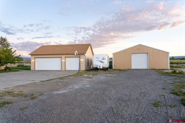 a view of a house with a yard and garage