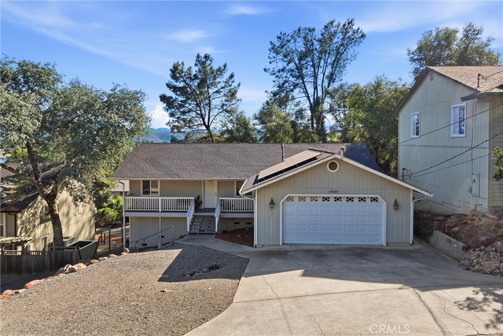 18685 Oak Grove Road Hidden Valley Lake, CA 95467 - Photo 36 of 52 a front view of a house with a garden and trees