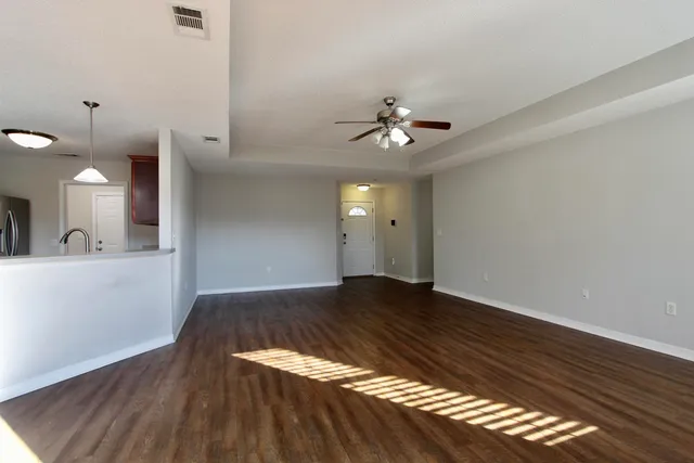 a view of an empty room and wooden floor