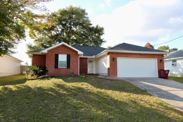 a view of a house with a yard and garage