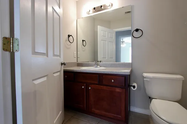 a bathroom with a toilet a sink and mirror