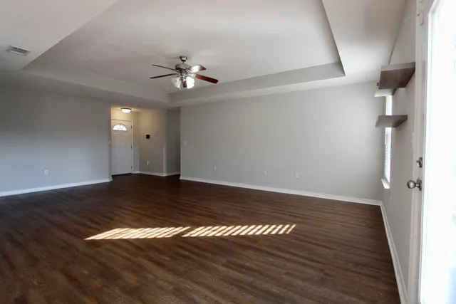 a view of empty room with wooden floor