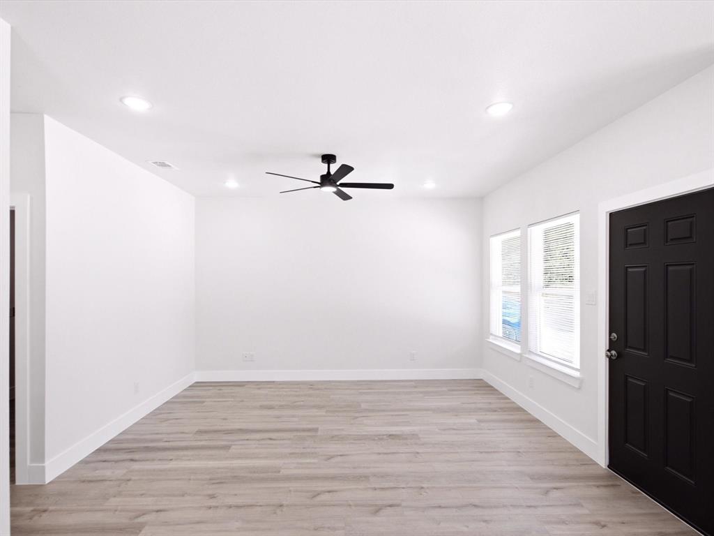 105 Oak Ridge Road Mabank, TX 75156 - Photo 6 of 34 Recessed ceiling lighting, wood-finish flooring, white walls, and a black ceiling fan