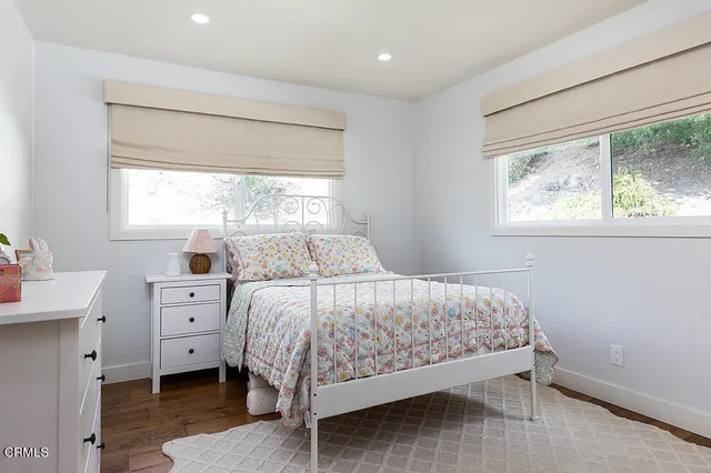 a bedroom with a large bed and a large window