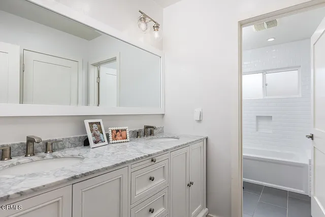 a bathroom with a granite countertop sink a mirror and a