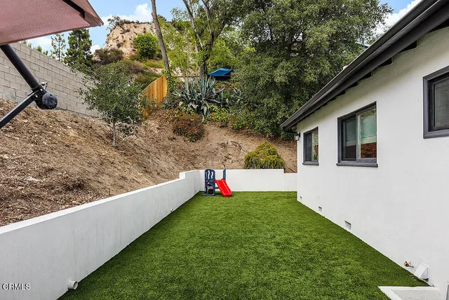 a view of an outdoor space and yard from the balcony