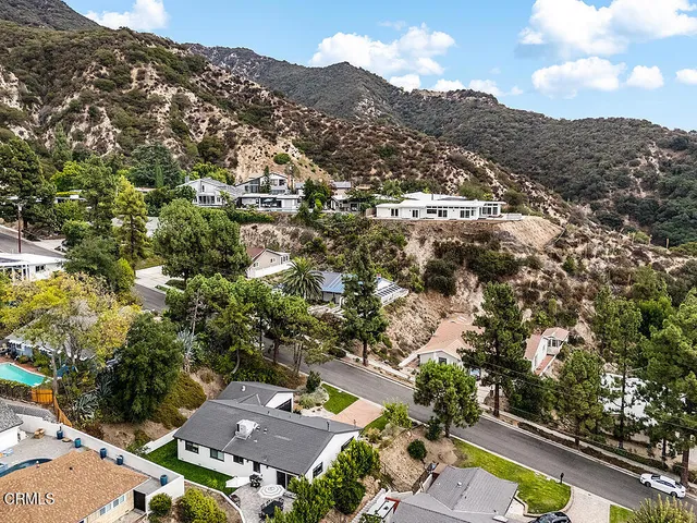 an aerial view of residential houses with outdoor space