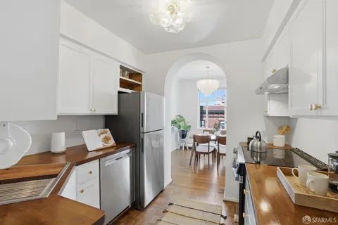 a living room with furniture a dining table and wooden floor