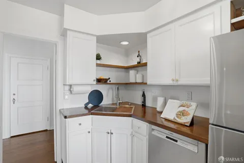 a kitchen with stainless steel appliances granite countertop a sink and a refrigerator