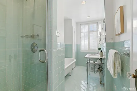 a bathroom with a shower a sink and a mirror