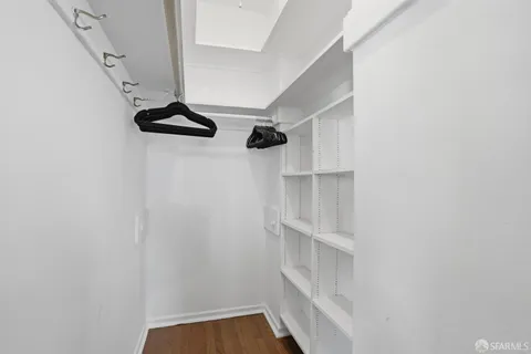 a view of walk in closet with empty racks