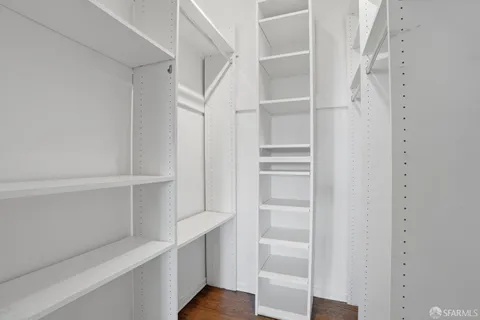 a view of walk in closet with empty racks