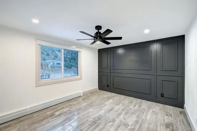 a view of empty room with cabinet and ceiling fan