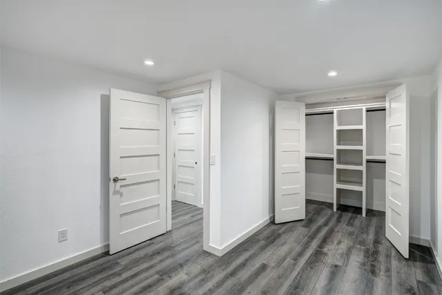 a view of walk in closet with empty racks