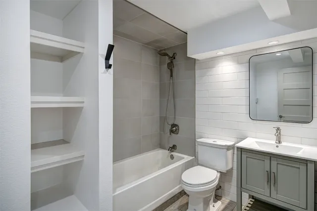a bathroom with a sink toilet and shower